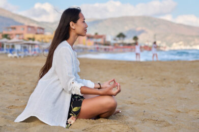 young-woman-practicing-yoga-on-the-beach-2022-03-29-23-50-50-utc